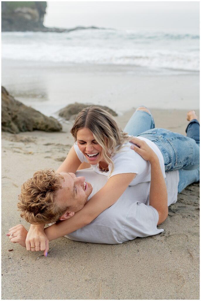 An image of couple on the beach laying down