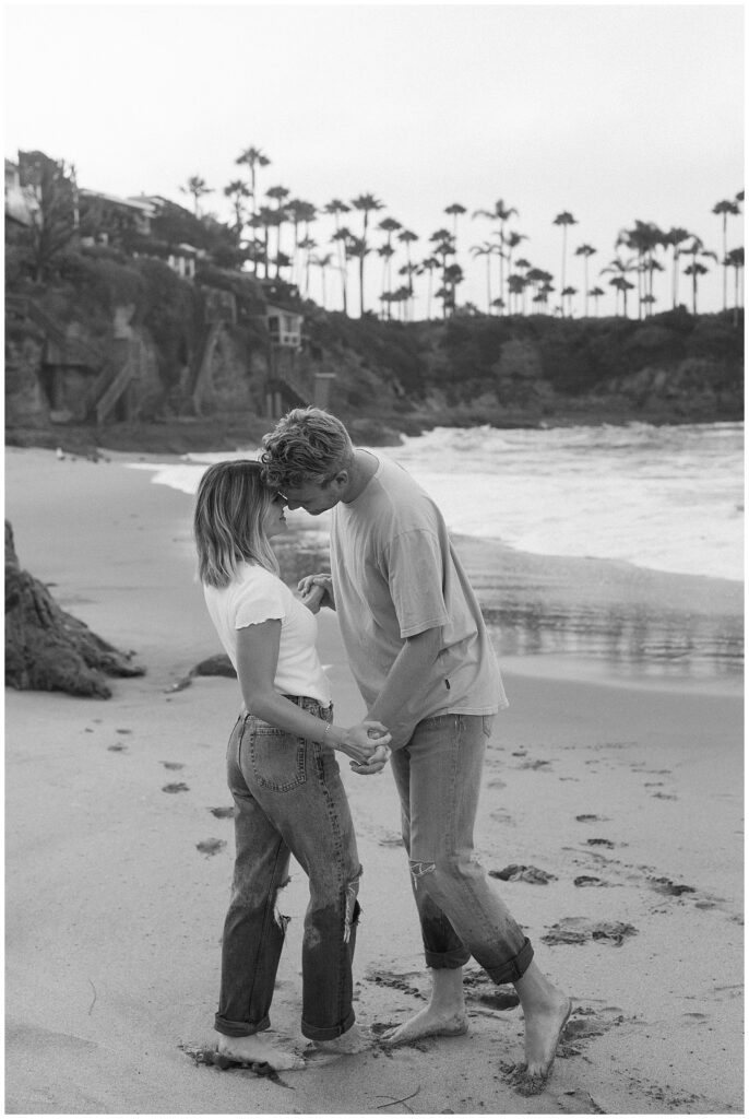 An image of couple on the beach hugging