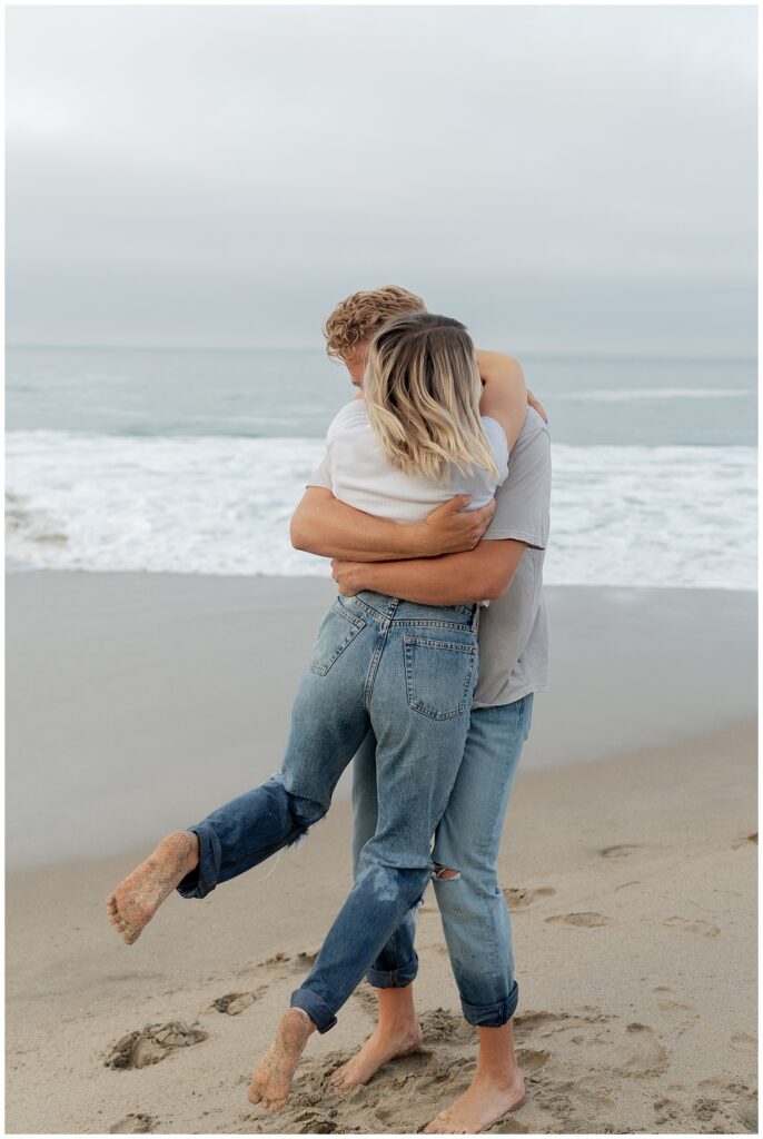An image of couple on the beach hugging