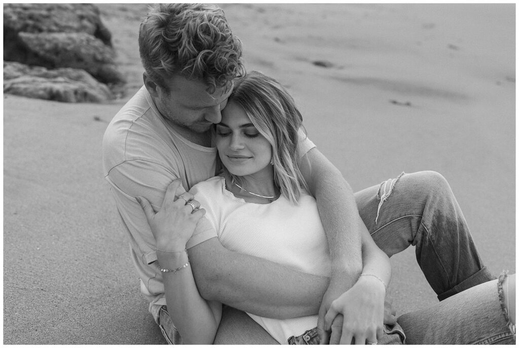 An image of couple on the beach hugging