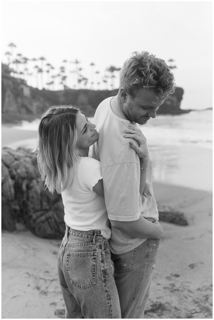 An image of couple on the beach hugging