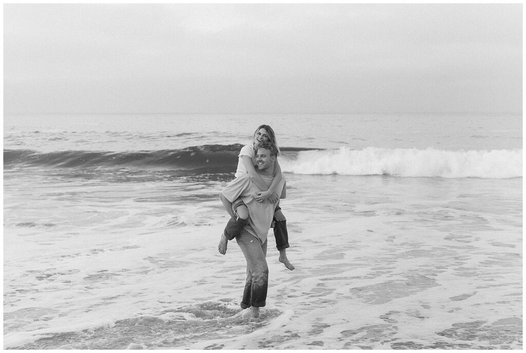 An image of couple giving piggy back ride in the water