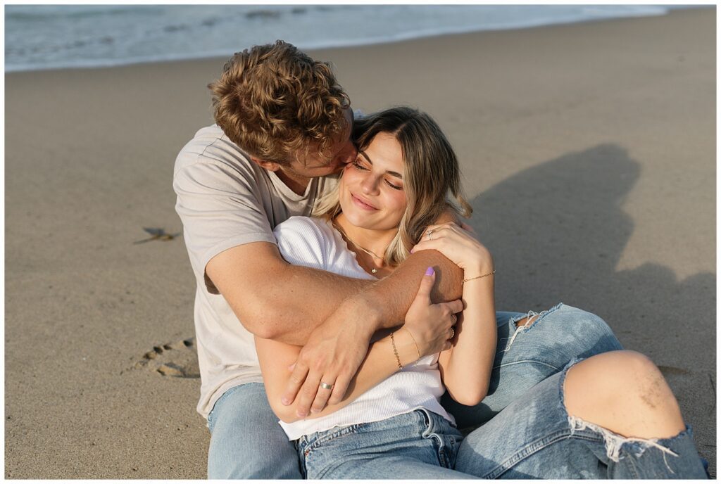An image of couple on the beach hugging